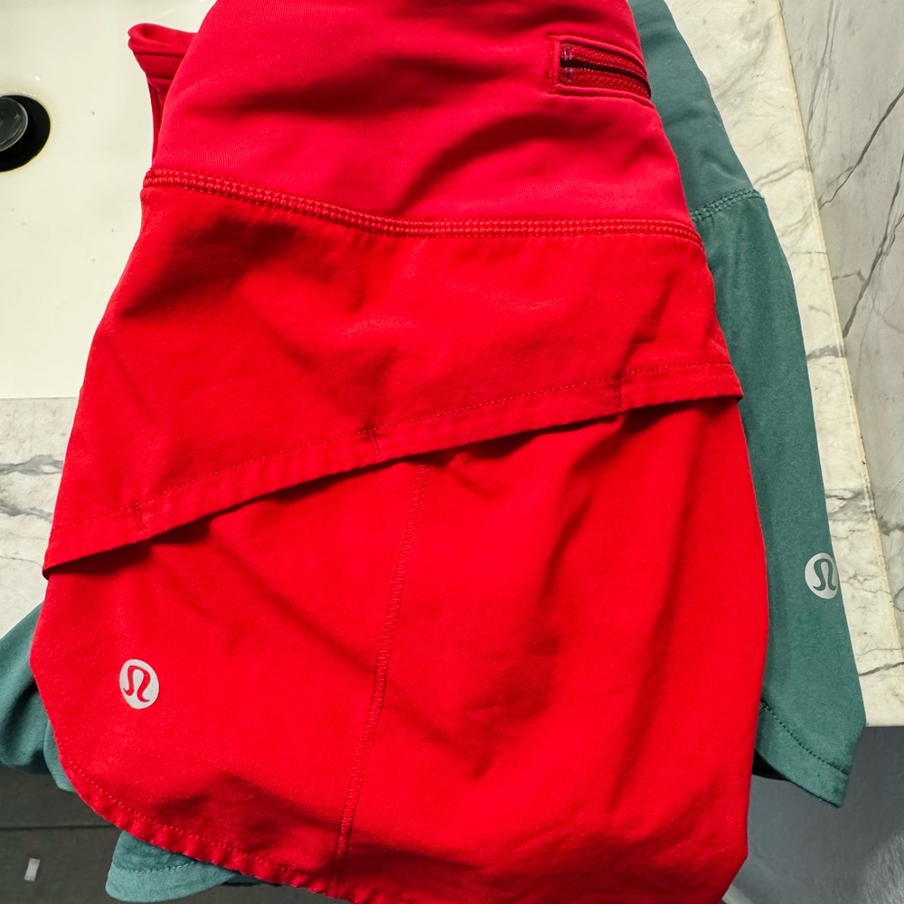 Two pairs of Lululemon Red and Green Athletic Shorts